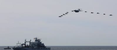 220606-N-DE439-1446 BALTIC SEA (June 6, 2022) German, Finnish, Swedish, and U.S. aircraft fly in formation above type 702 Berlin-class replenishment ship FGS Berlin (A1411) as it sails in the Baltic Sea during exercise BALTOPS22. BALTOPS22 is the premier maritime-focused exercise in the Baltic Region. The exercise, led by U.S. Naval Forces Europe-Africa, and executed by Naval Striking and Support Forces NATO, provides a unique training opportunity to strengthen combined response capabilities critical to preserving freedom of navigation and security in the Baltic Sea. (U.S. Navy photo by Mass Communication Specialist 2nd Class Almagissel Schuring)